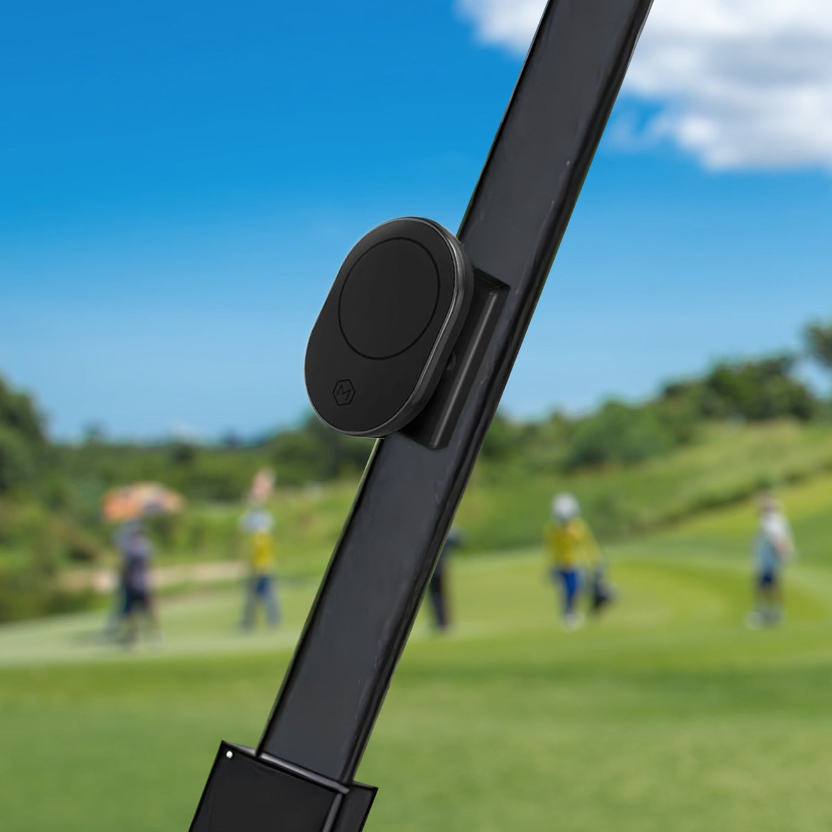 Close-up of black magnetic wall mount on golf cart, holding a smartphone with golf course map, durable plastic design