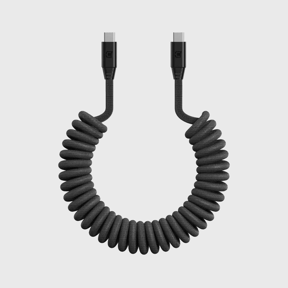 Black coiled USB-C to USB-C cable with braided material, magnetic connectors, designed for fast charging, 1 meter length, hassle-free storage