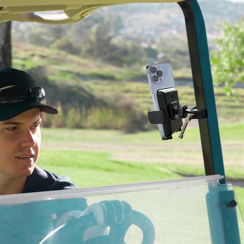 Golf cart with mounted phone holder securing a smartphone, used for GPS navigation and recording golf game footage outdoors.