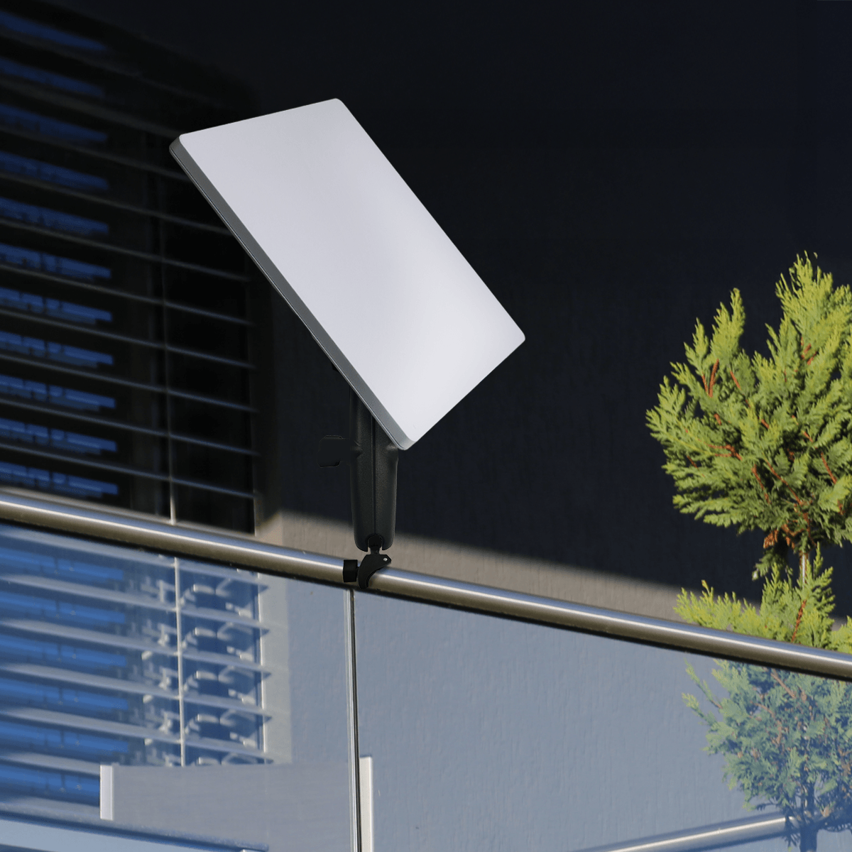 Starlink Mini mounted on a black handlebar mount on a balcony railing, compact satellite dish with adjustable arm, outdoor installation SKU: M9560-A1